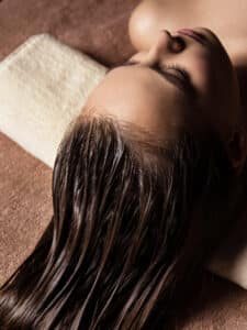 young woman receiving hair care procedure spa salon beauty treatment spa salon
